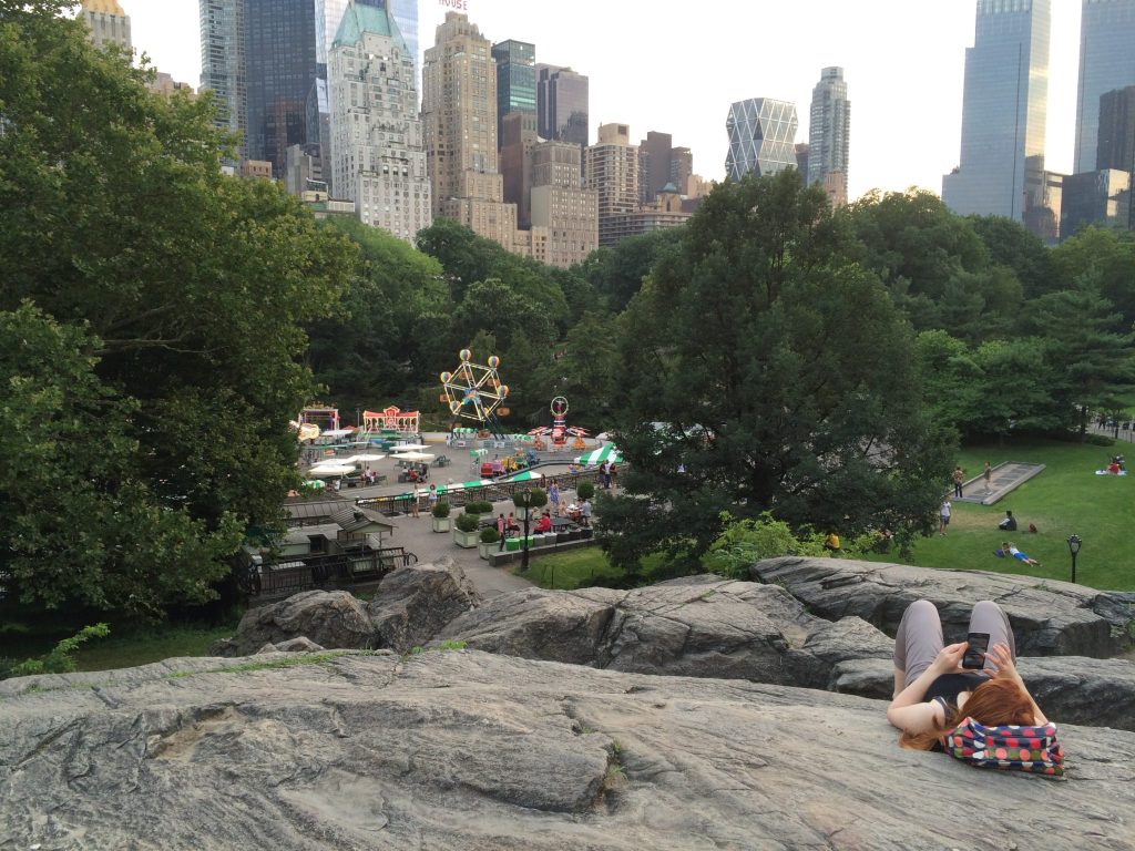 A girl laying on the huge rock overlooking the Victoria Gardens Amusement Park.