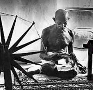 Gandhi with a spinning wheel in India