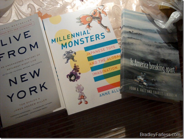 Three books from on the side of the road, put out as trash.