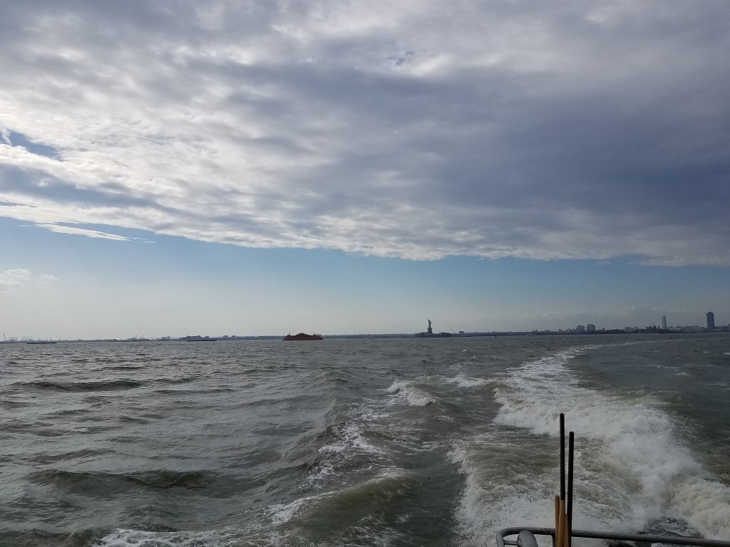 View of the Statue of Liberty in the distance from the water taxi to Red Hook, Brooklyn from Pier 11 Slip A in Manhattan.