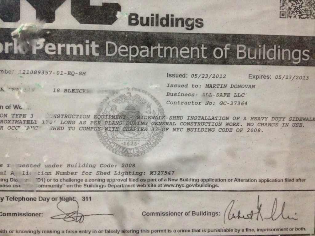 Work Permit at construction site for BMW with hood crushed by backhoe.