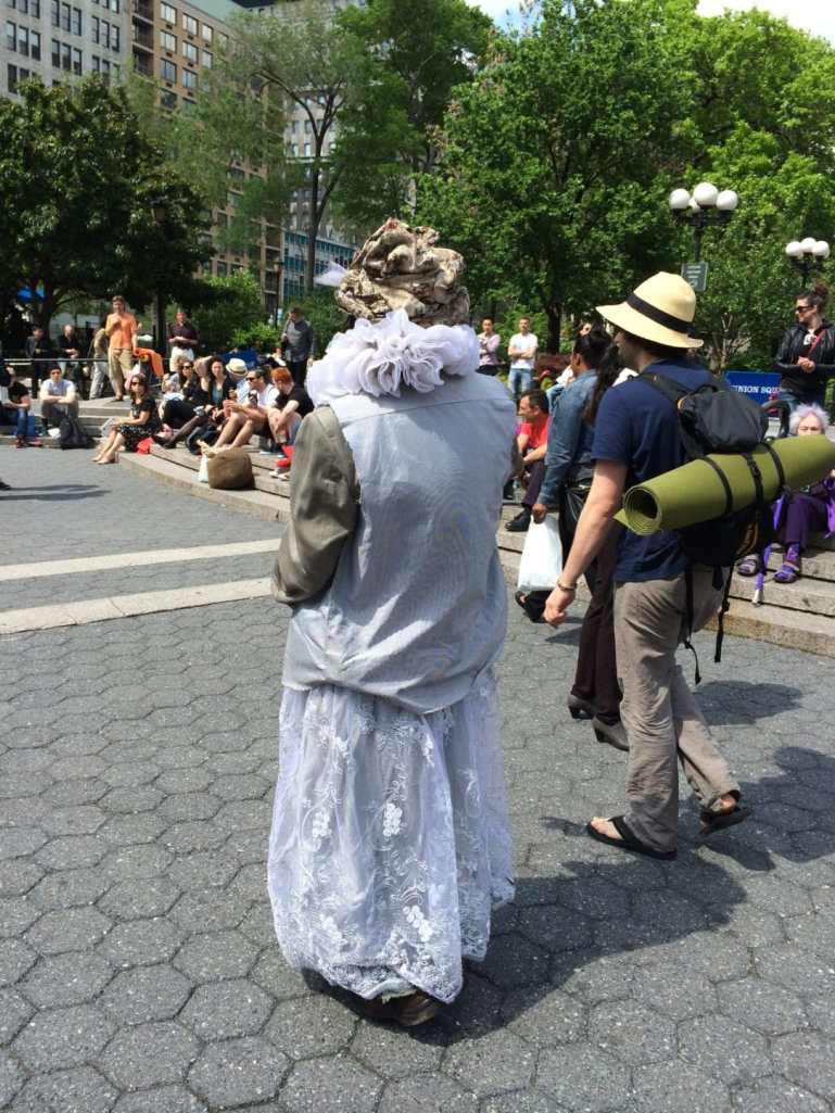 This guy was taking a break from dancing to the tune of a nearby Buddhist meditation group. Shortly after this, he took a bag of trash from the public bin and walked away with it.