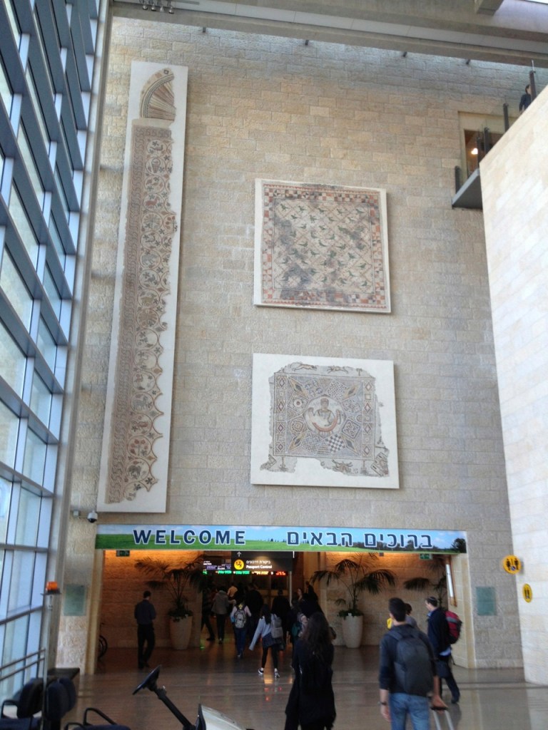 Mosaics on the wall, heading into the customs/border control area.